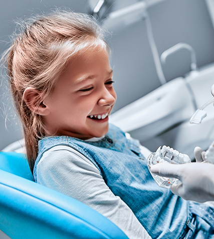 Girl grinning in dental chair