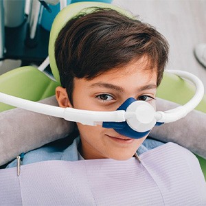 Child in patient’s chair with laughing gas mask