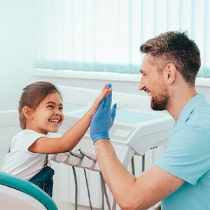 Dentist and child high-fiving