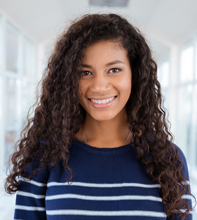 Smiling teenage girl in blue sweater