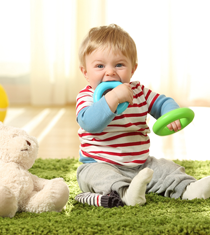 Toddler chewing on a teething ring