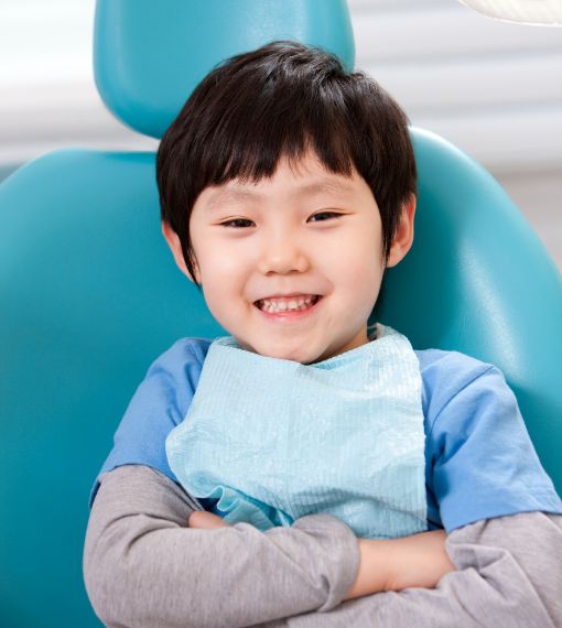 Young boy smiling in dental chair after seeing pediatric emergency dentist in Portland