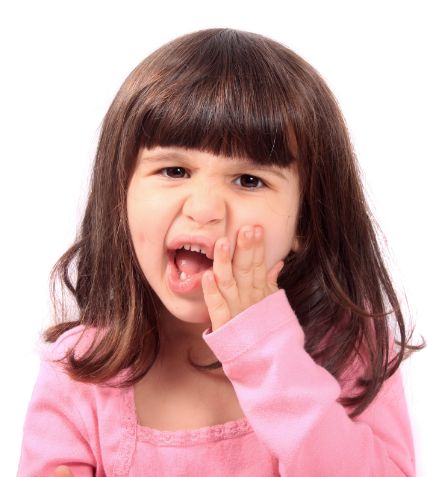 Young girl holding the side of her face in pain