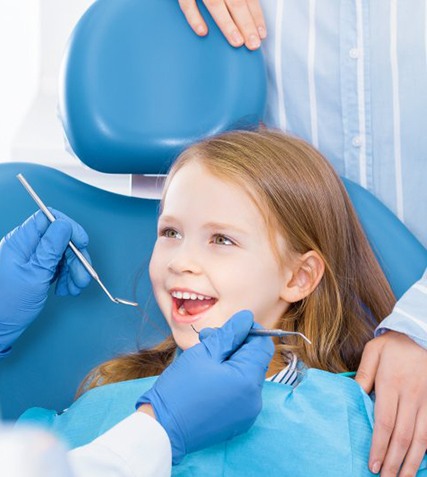 Child smiles at dentist