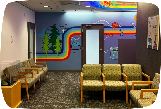 Waiting area with rainbow stripe on wall in pediatric dental office in Portland