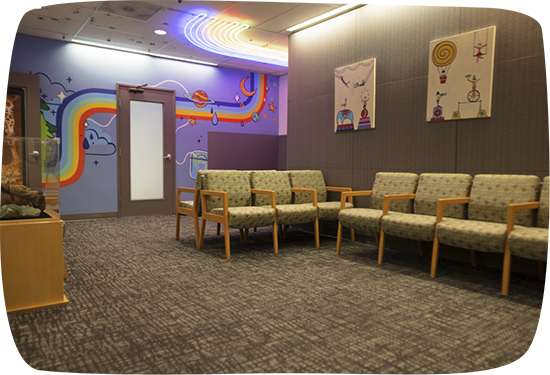 Waiting area with rainbow stripe on wall in pediatric dental office in Portland