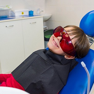 a smiling child in a dental chair