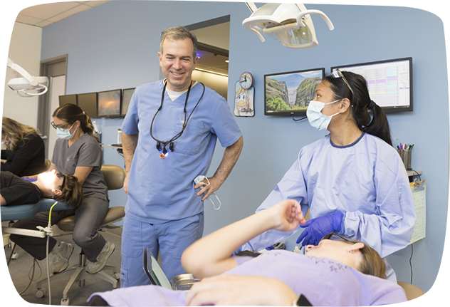 Dentist talking to a young woman in the dental chair