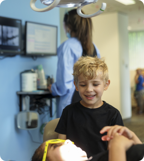 photo of smiling team member with child patient