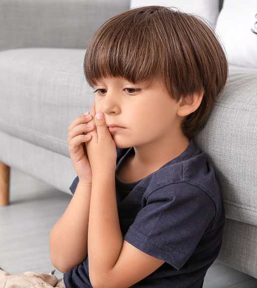 Boy holding his cheek in pain needing pulp and root canal treatment in Portland