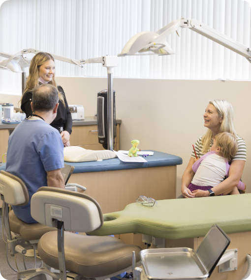 Dr. Pike and pediatric dental team member talking to parent