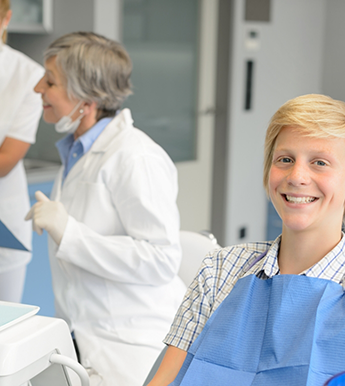 Teenage boy smiling in dental chair