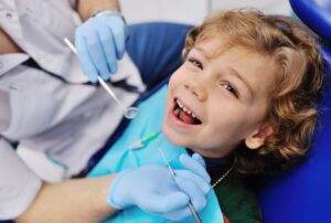 Child smiling while at the dentist