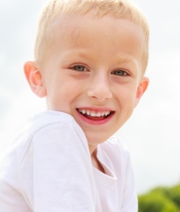 smiling kid in white shirt